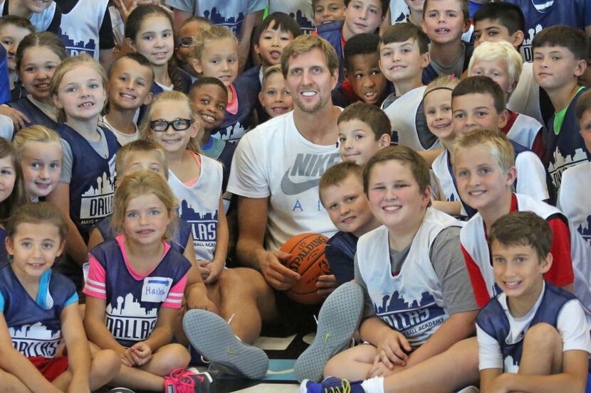 Dirk Nowitzki poses for a photo with the kids attending Mavs Basketball Academy Summer Hoop...