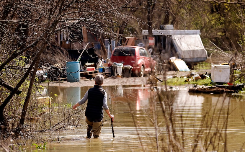 Sharon Grigsby navigated the receding Trinity River floodwater while headed to check on...