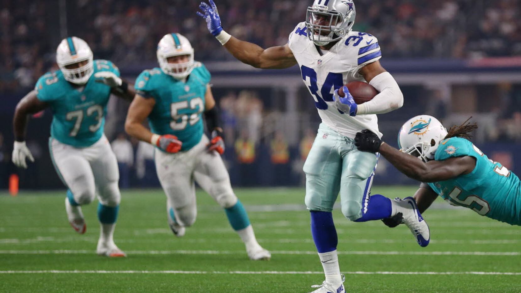 Miami Dolphins free safety Walt Aikens (35) attempts to tackle Dallas Cowboys running back...