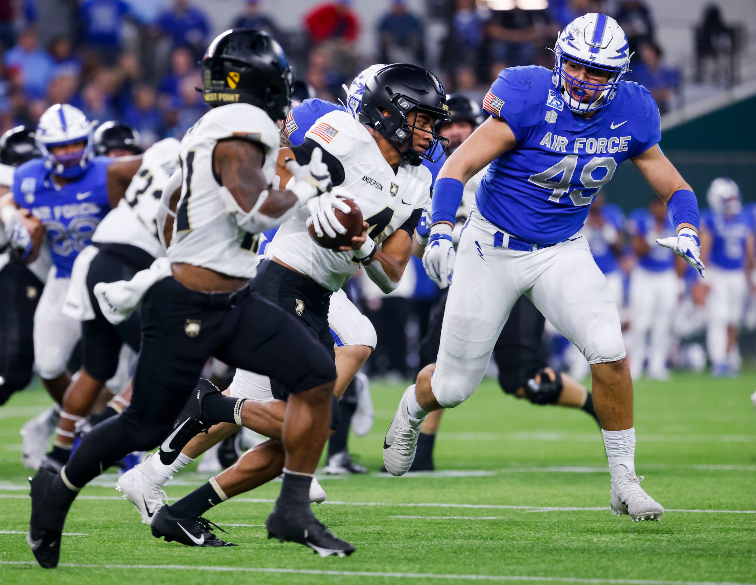 Army Black Knights quarterback Christian Anderson (4) runs by Air Force Falcons defensive...