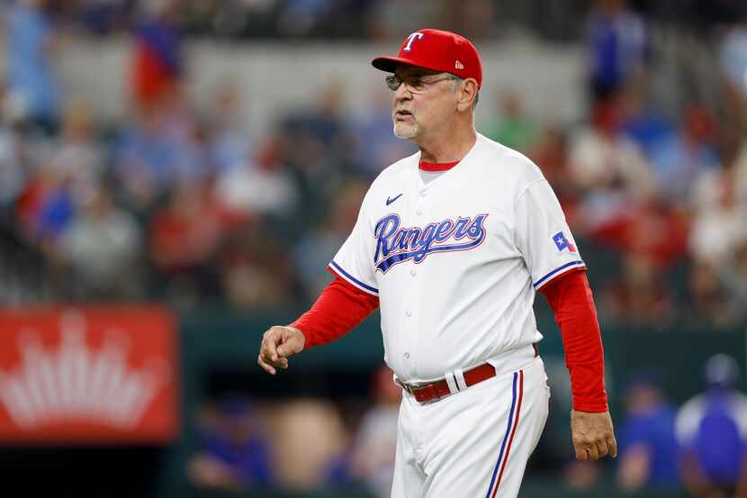 Texas Rangers manager Bruce Bochy (15) walks to the dugout after making a pitching change in...