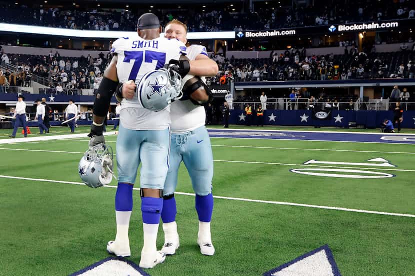 Dallas Cowboys center Tyler Biadasz (63) hugs offensive tackle Tyron Smith (77) following...