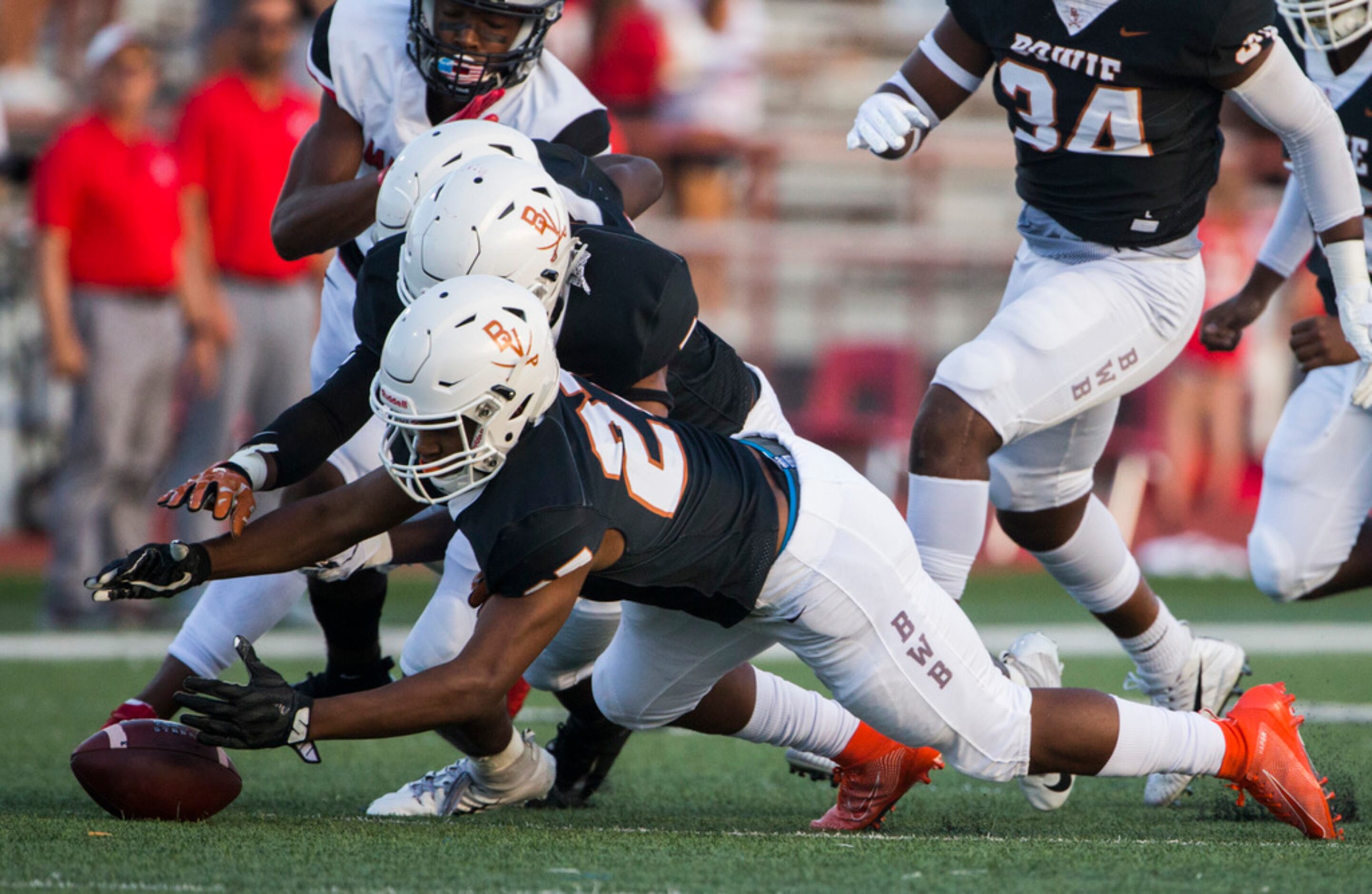 Arlington Bowie defensive back Kameron Sanders (27) recovers a fumble by Flower Mound Marcus...