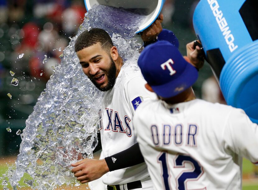 Texas Rangers right fielder Nomar Mazara (30) is doused by Texas Rangers shortstop Elvis...