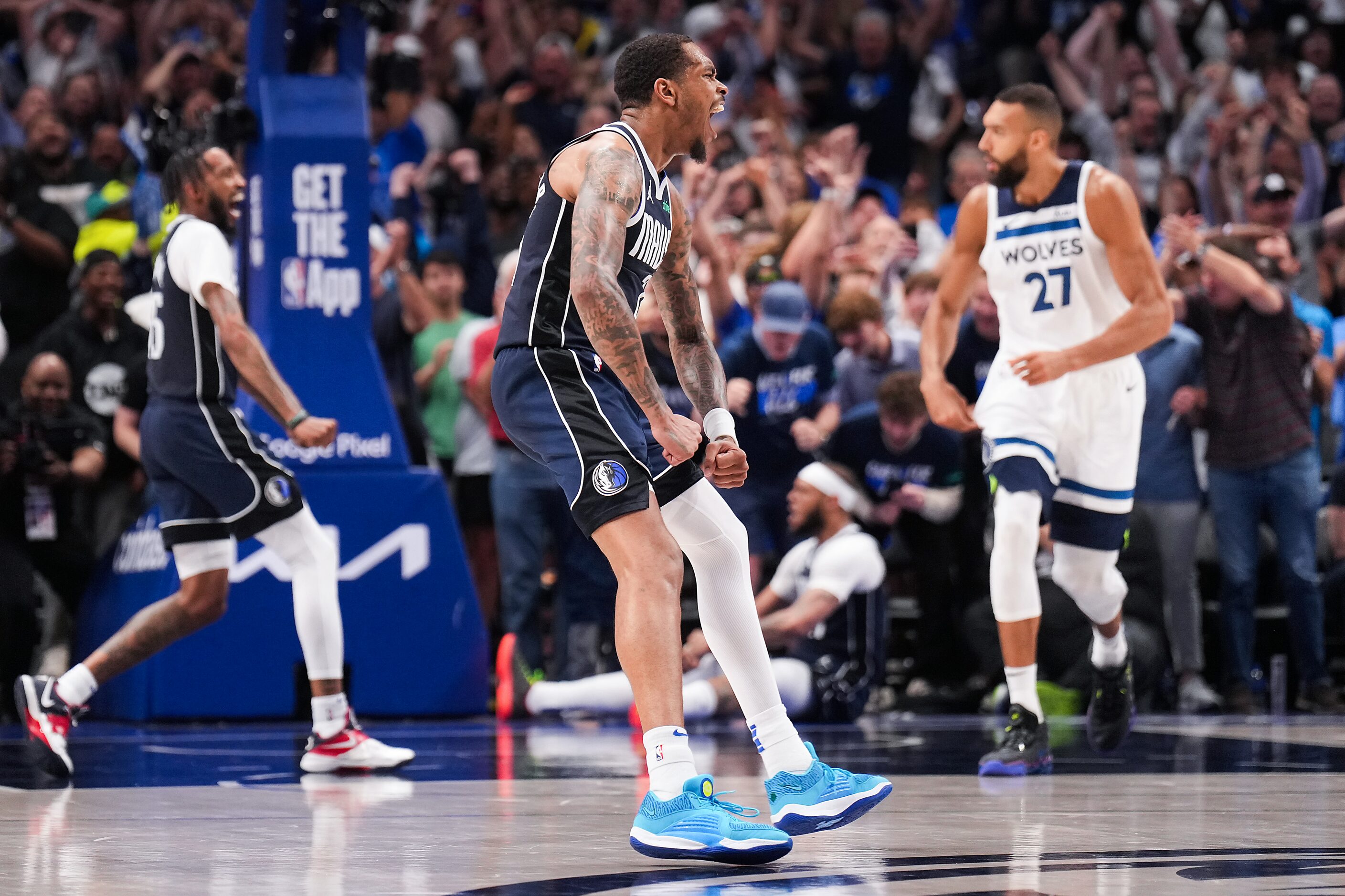 Dallas Mavericks forward P.J. Washington celebrates a dunk by forward Derrick Jones Jr....