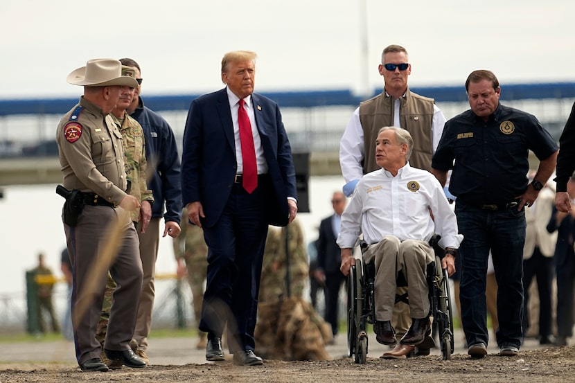 Republican presidential candidate Donald Trump walks in Shelby Park during a visit to the...