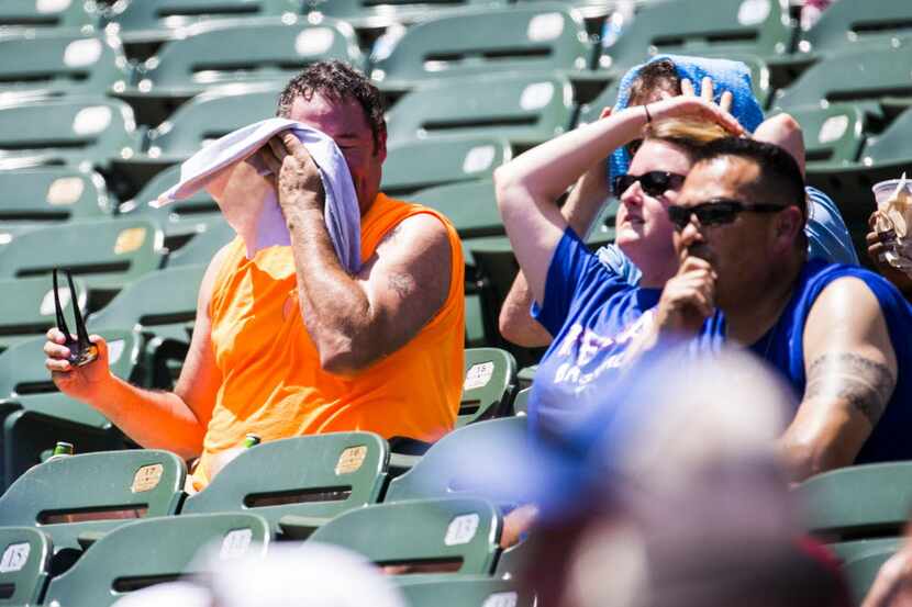 A sweaty Texas Rangers fan towels off in the sizzling section of Globe Life Park in Arlington.