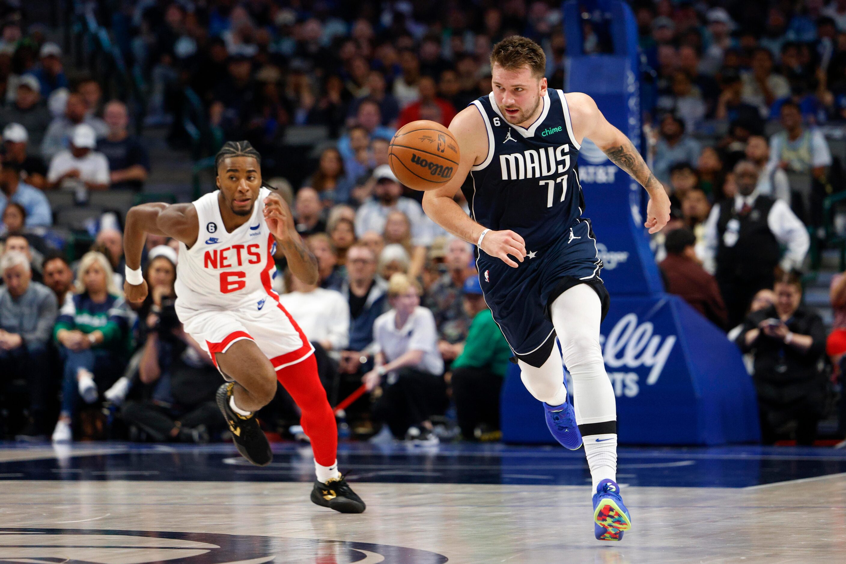 Dallas Mavericks guard Luka Doncic (77) pushes the ball up court ahead of Brooklyn Nets...