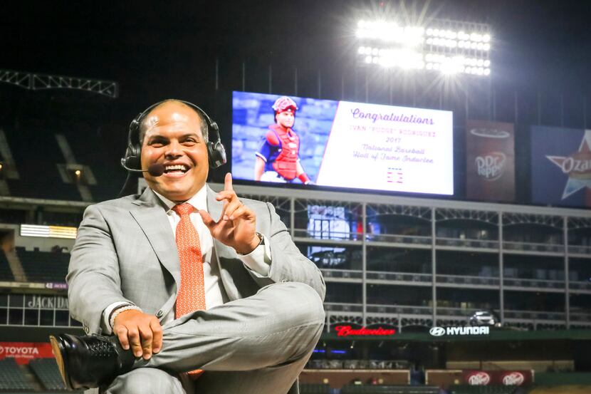 The scoreboard features congratulation behind him as former Texas Rangers catcher Ivan...