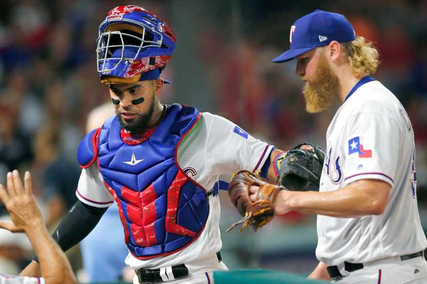 Texas Rangers catcher Robinson Chirinos (61, left) congratulates starting pitcher Andrew...