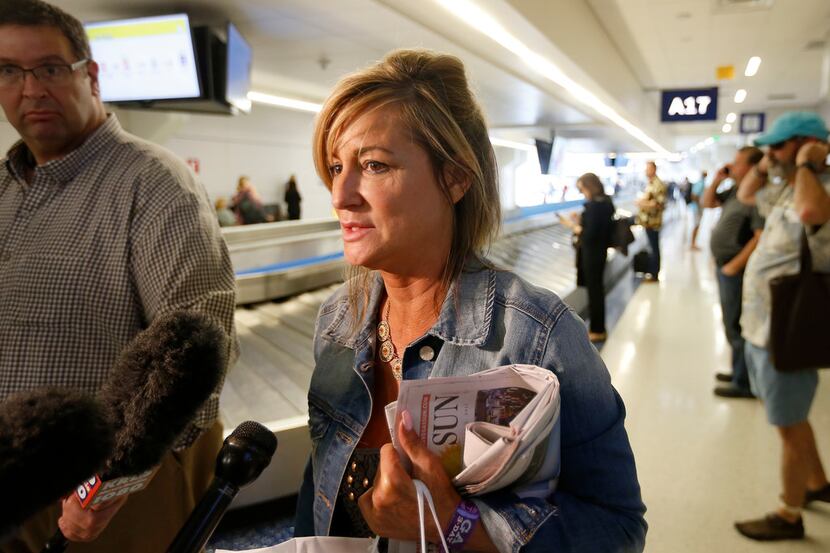 Teri Guerra, of Fort Worth, talks with the media as she arrives at Dallas/Fort Worth...