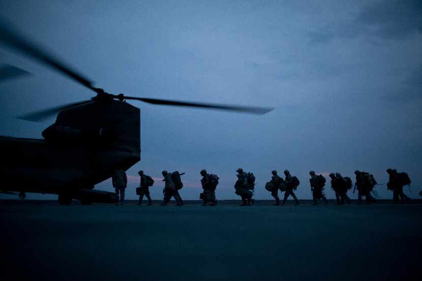 U.S. soldiers board a transport helicopter in Kunduz, Afghanistan, in March, 2011. After...