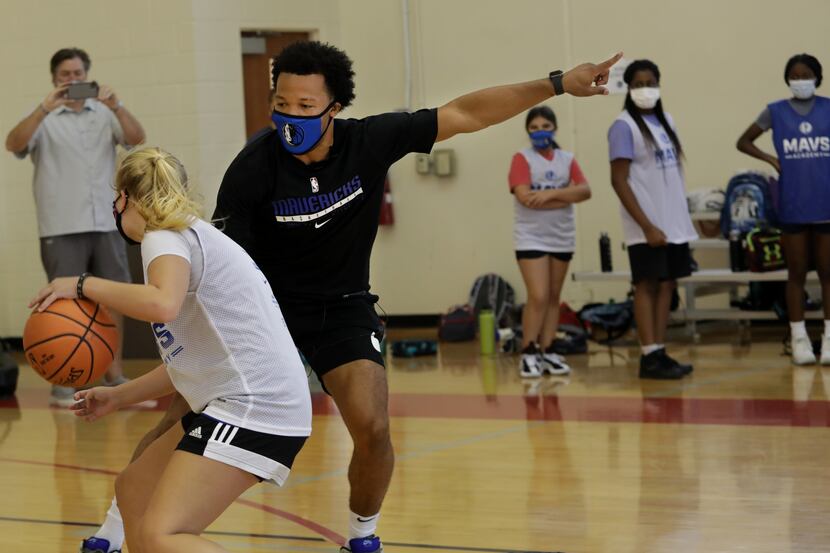 15-year-old Charlotte Collins, left, goes head to head with Jalen Brunson as he interacts...