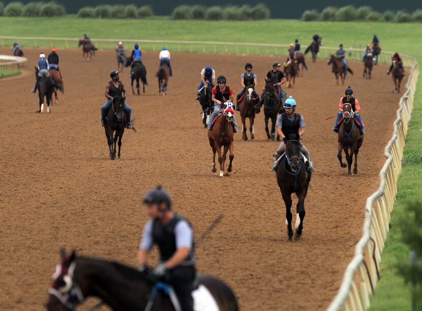 Riders work their trainers horses on the track at Lone Star Park at Grand Prairie, Texas...