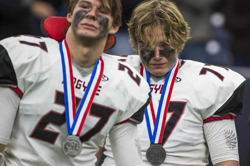 Argyle's Hudson Speed (27) and Jaxon Frazier (77) stand with their second place medals after...