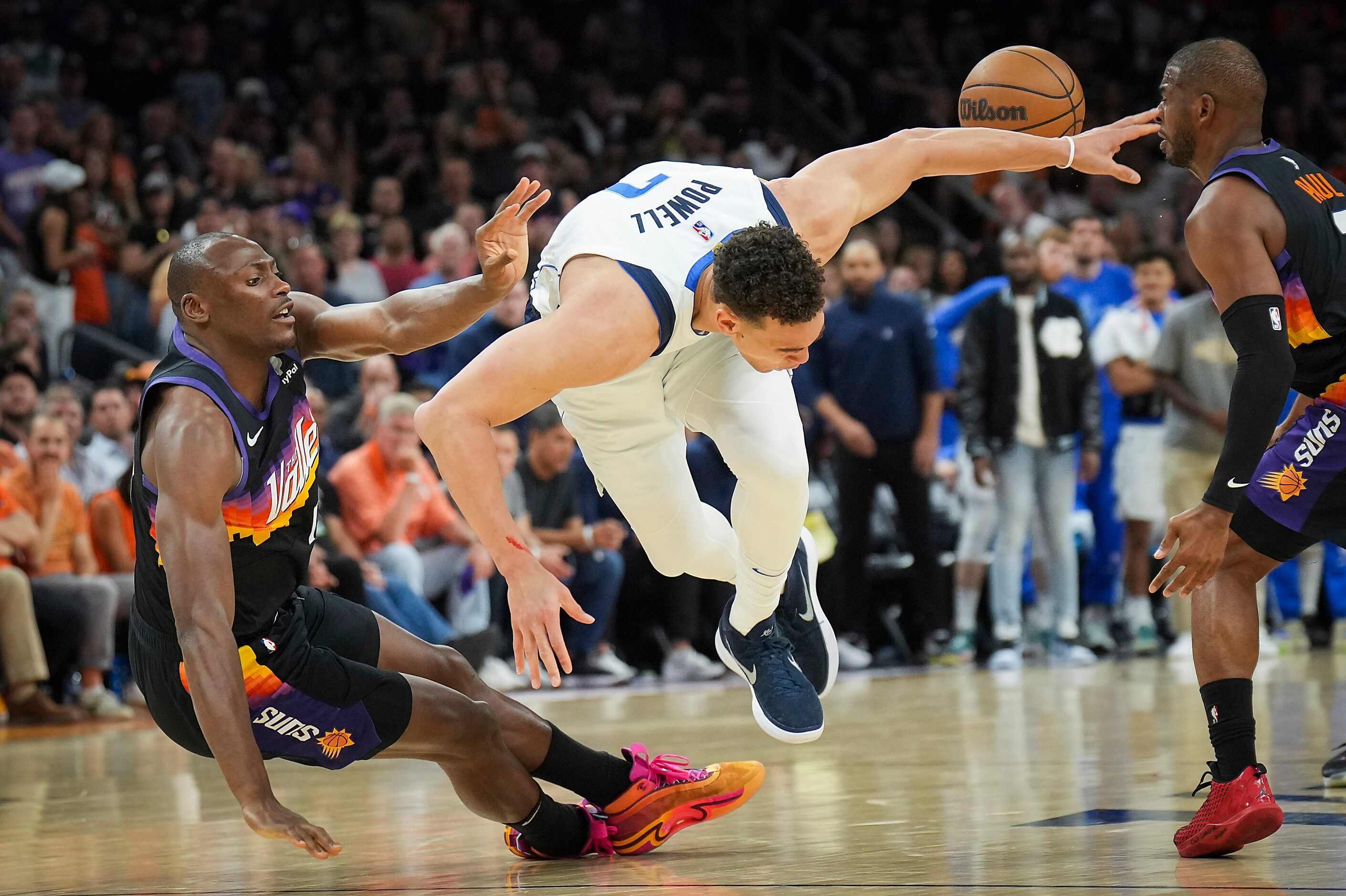 Dallas Mavericks center Dwight Powell (7) is fouled by Phoenix Suns center Bismack Biyombo...