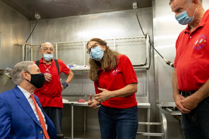 Texas Governor Greg Abbott (left) tours American Butchers with co-owners Desiree Wineland...