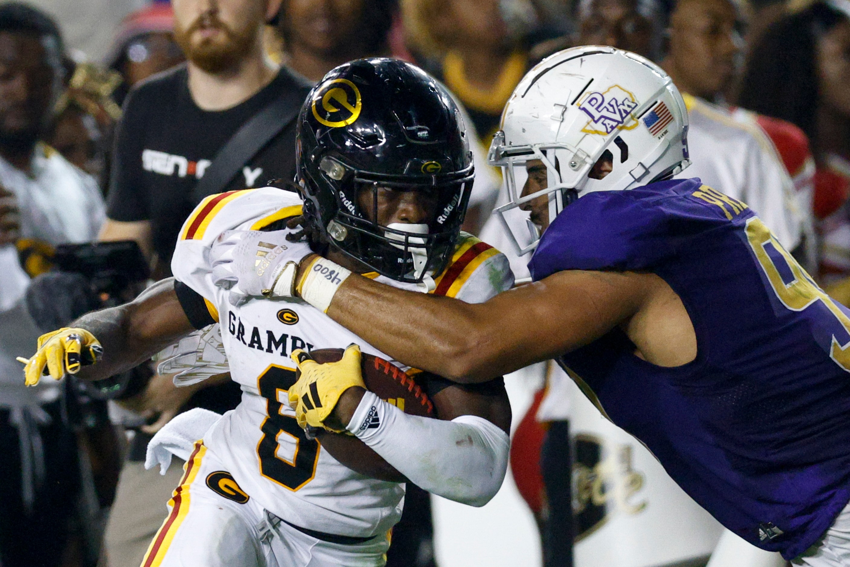 Prairie View A&M defensive lineman Calvin Pressley Jr. (99) tackles Grambling State running...