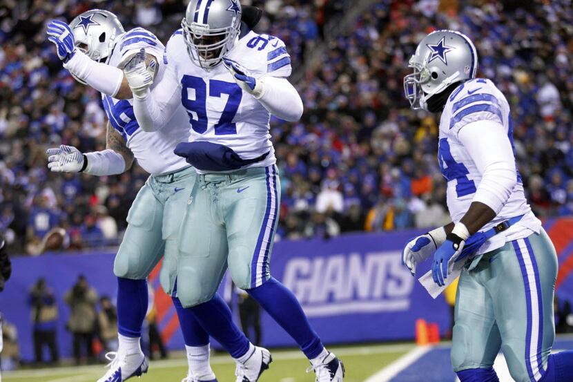 Dallas Cowboys defensive tackle Jason Hatcher (97) is congratulated on his sack by defensive...