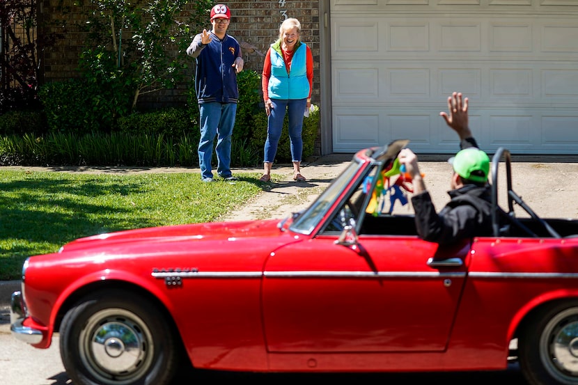 Alex Patterson and his mother, Connie Abookire, wave to birthday well-wishers outside the...