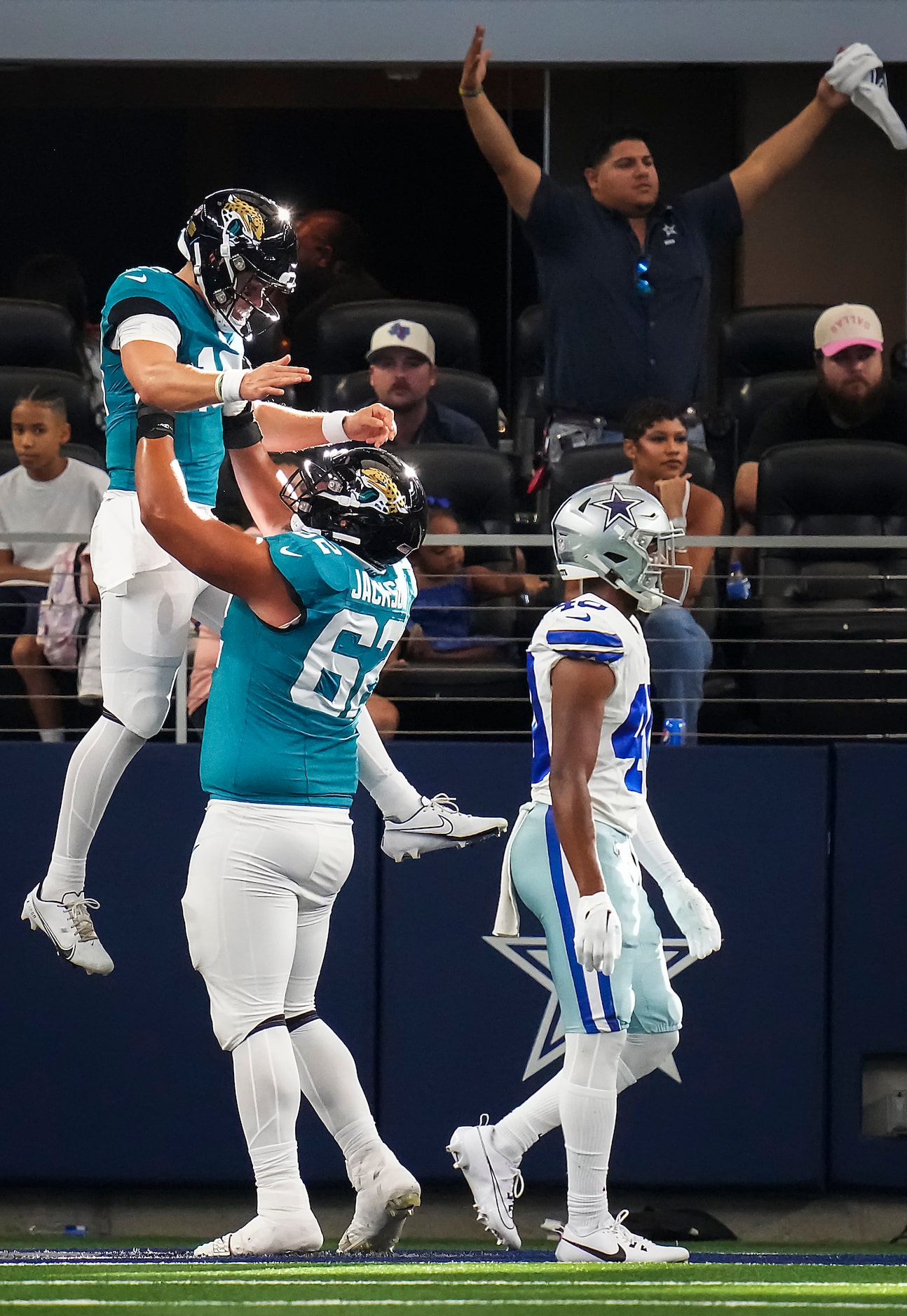 Jacksonville Jaguars quarterback Nathan Rourke (18) celebrates with guard Samuel Jackson...