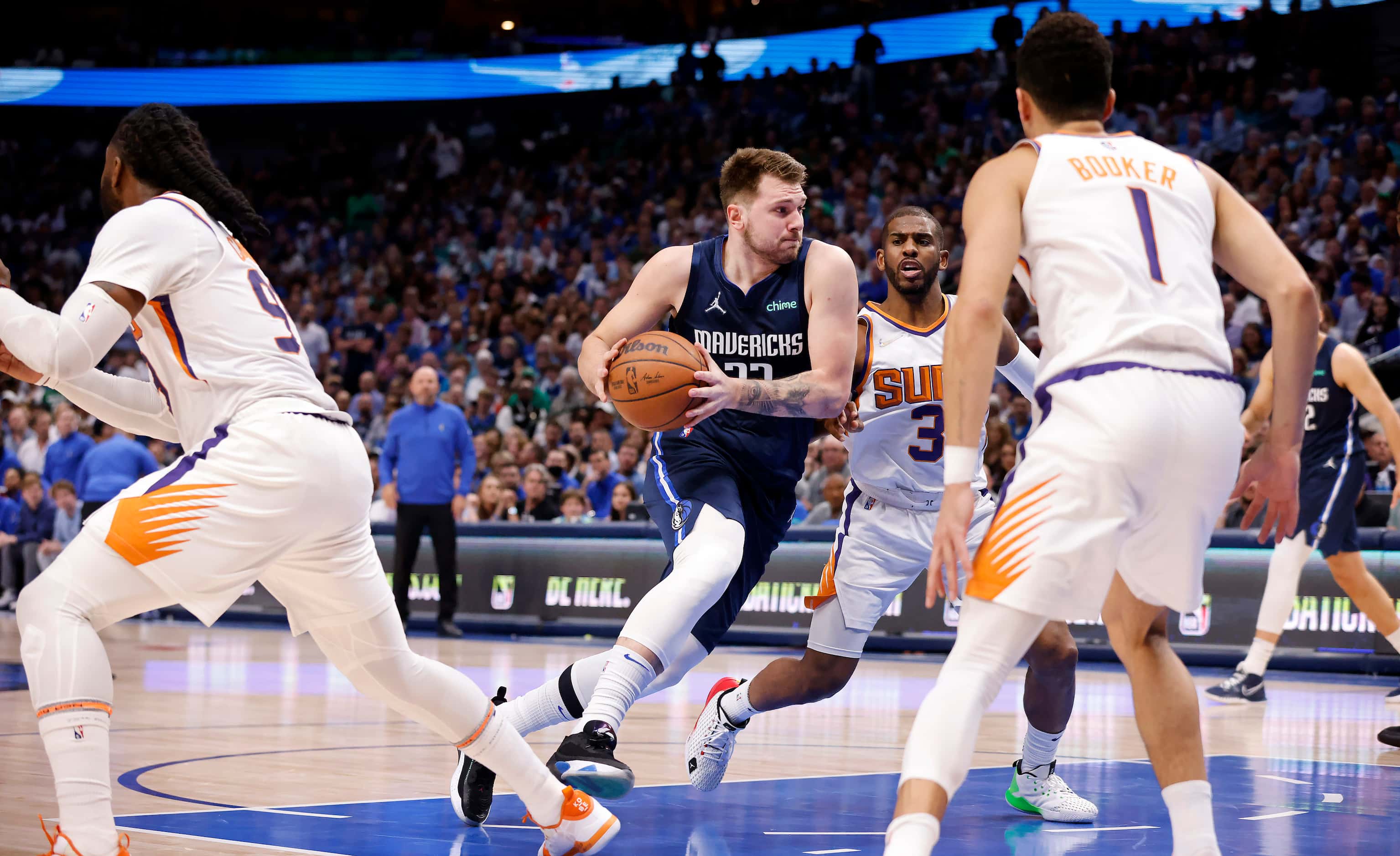Dallas Mavericks guard Luka Doncic (77) drives the lane past Phoenix Suns guard Chris Paul...