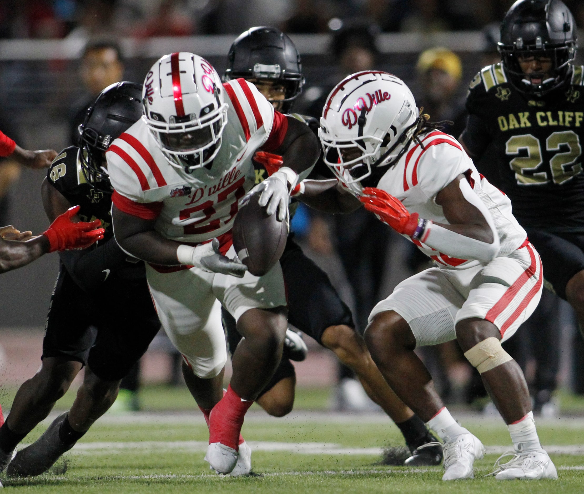 Duncanville's Jaqualon Armstrong (27), left, reaches to recover a fumbled touchdown as...