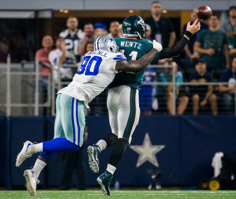 Dallas Cowboys defensive end Demarcus Lawrence (90) tackles Philadelphia Eagles quarterback...