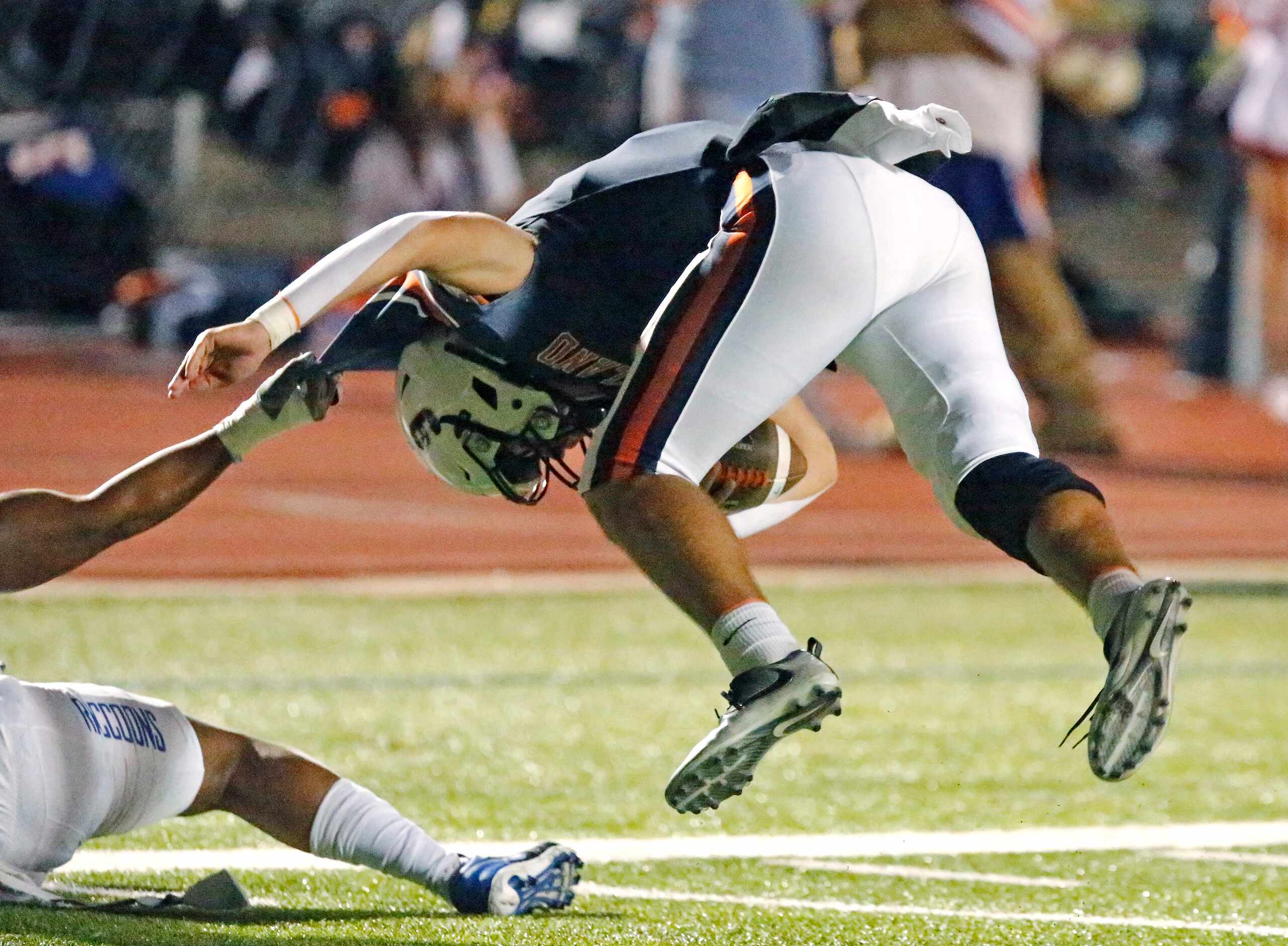 Wakeland High School quarterback Brennan Myer (9) is tossed out of bounds near the goal line...