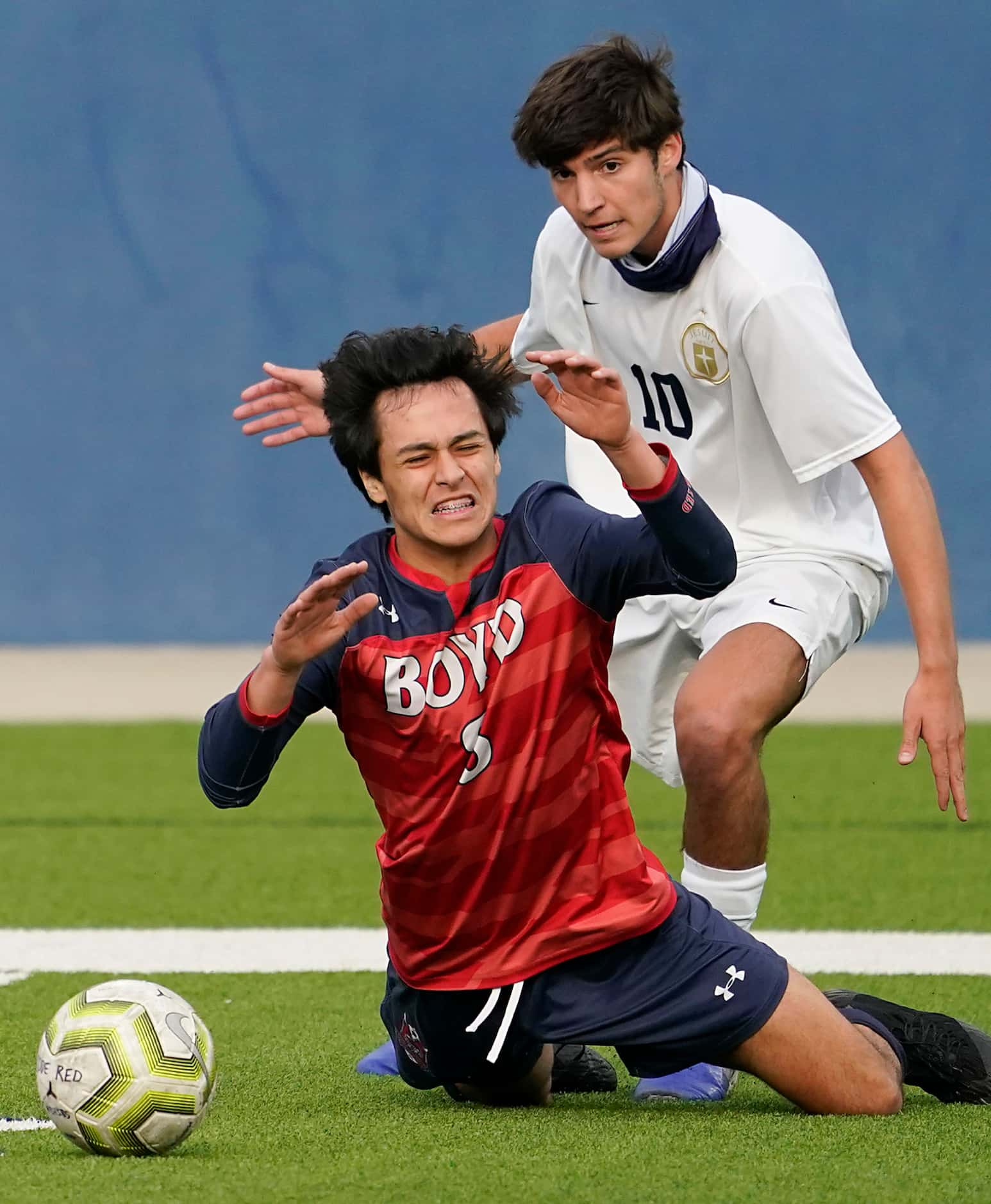 McKinney Boyd midfielder Daniel Ortiz (8) is brought down by Jesuit midfielder Santiago Day...