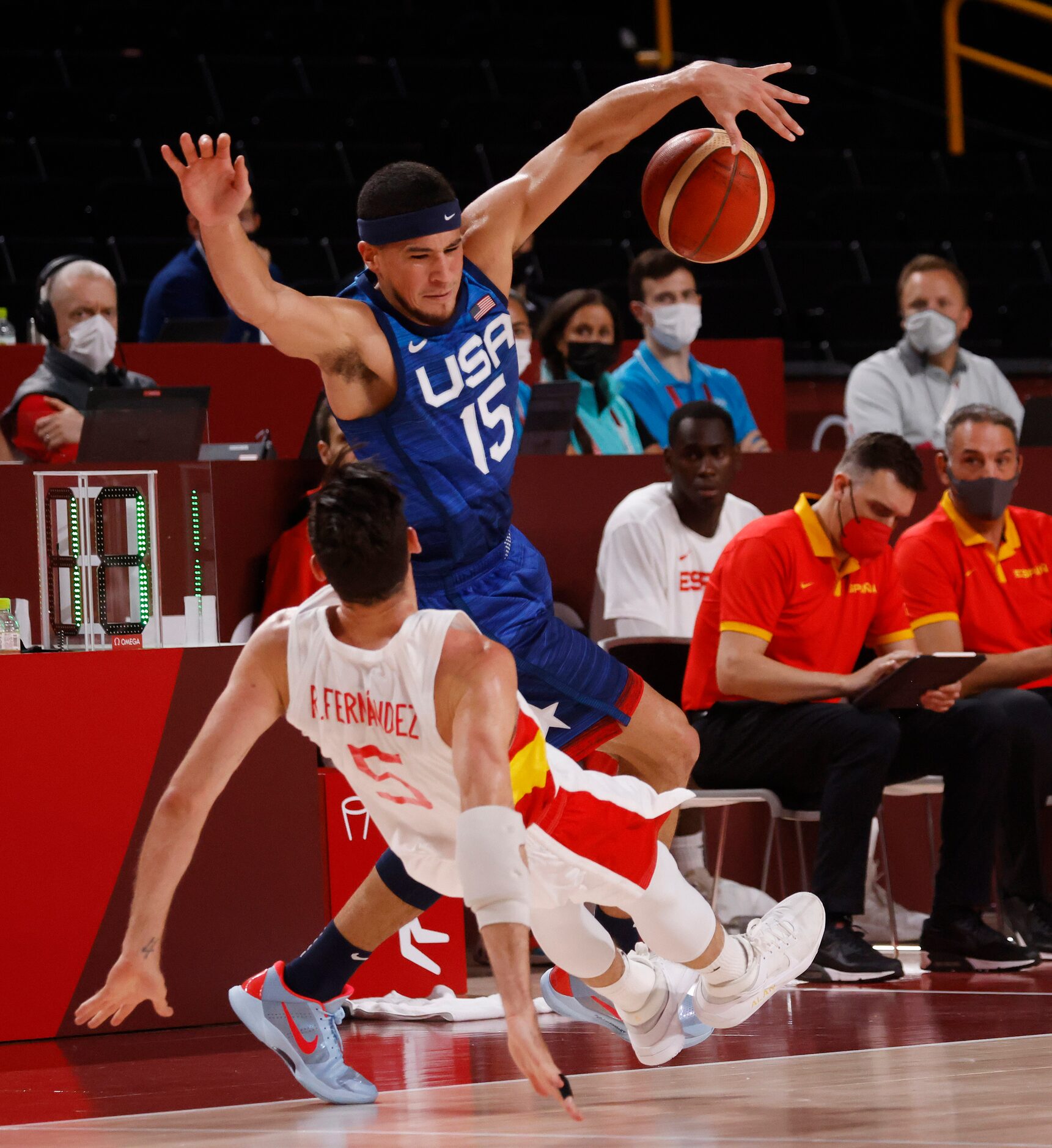 USA’s Devin Booker (15) is fouled by Spain’s Rudy Fernandez (5) during the first half of a...