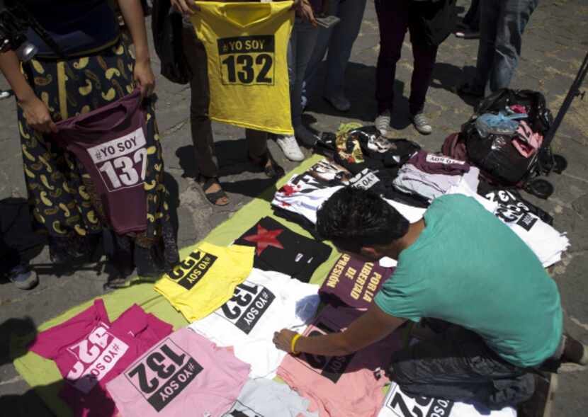 A vendor set out #YoSoy132 shirts for sale during a rally Wednesday in Mexico City. Some...