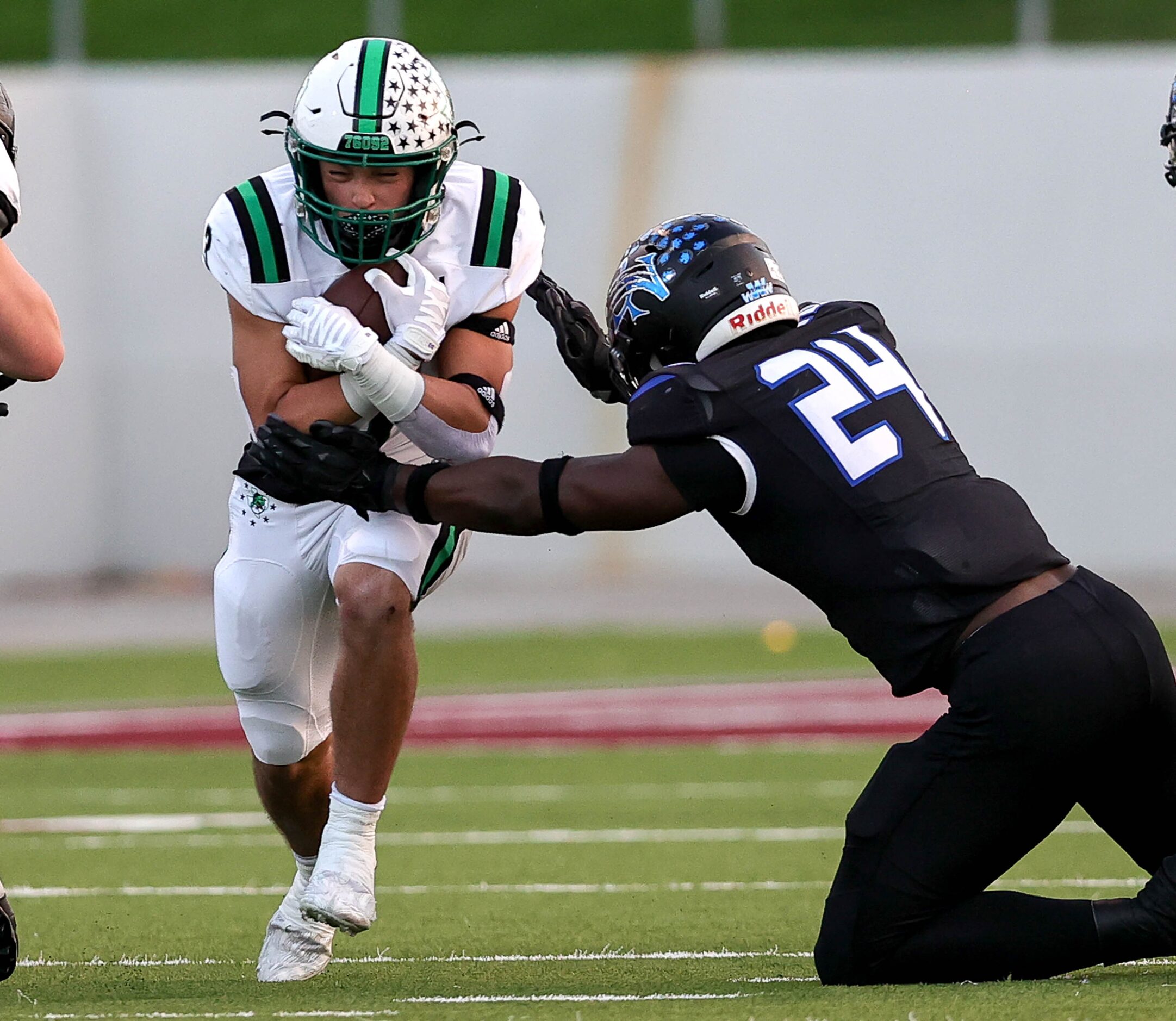 Southlake Carroll running back Davis Penn (left) tries to avoid Byron Nelson linebacker...