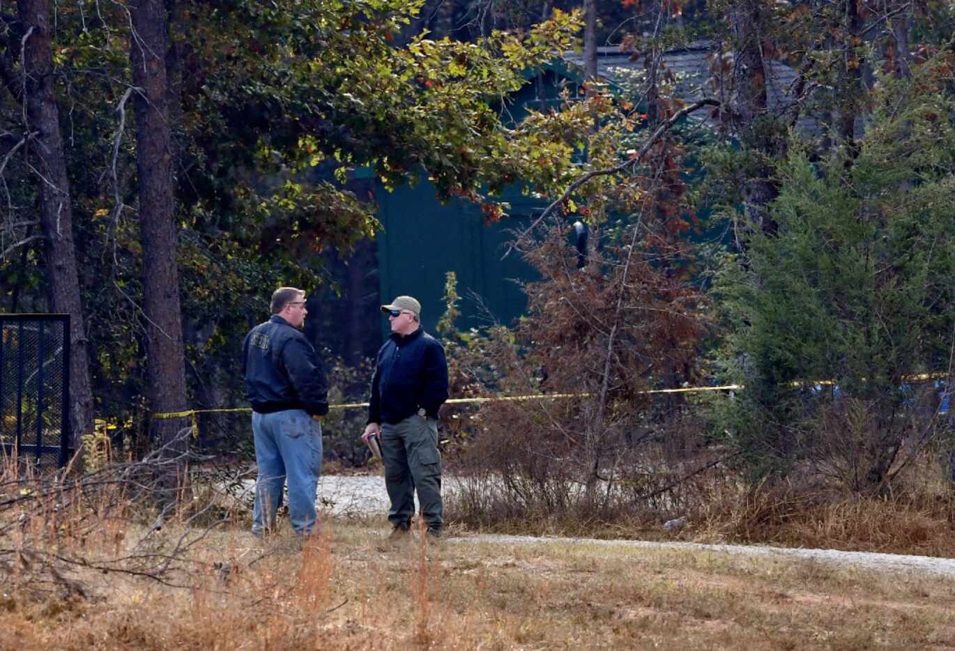 Law enforcement personnel stand near police tape on Todd Kohlhepp's property in Woodruff,...