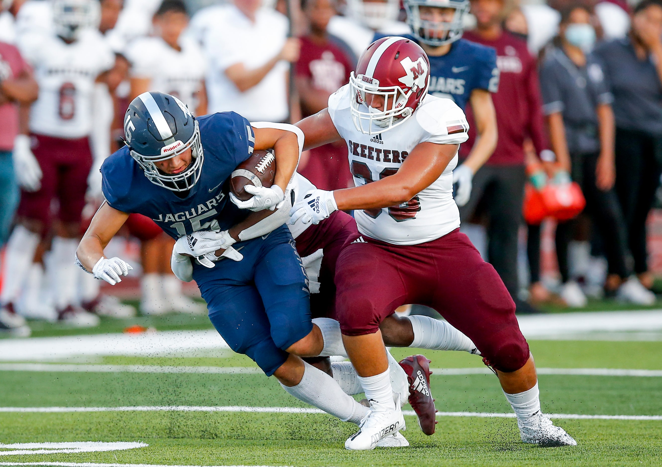 Flower Mound junior wide receiver Walker Mulkey (15) battles Mesquite junior linebacker...