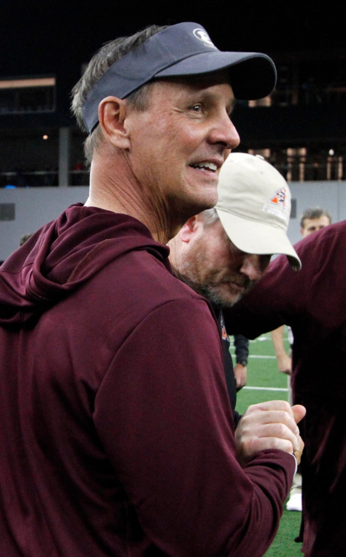 Ennis head coach greets supporters at mid field following his team's 43-36 overtime loss to...