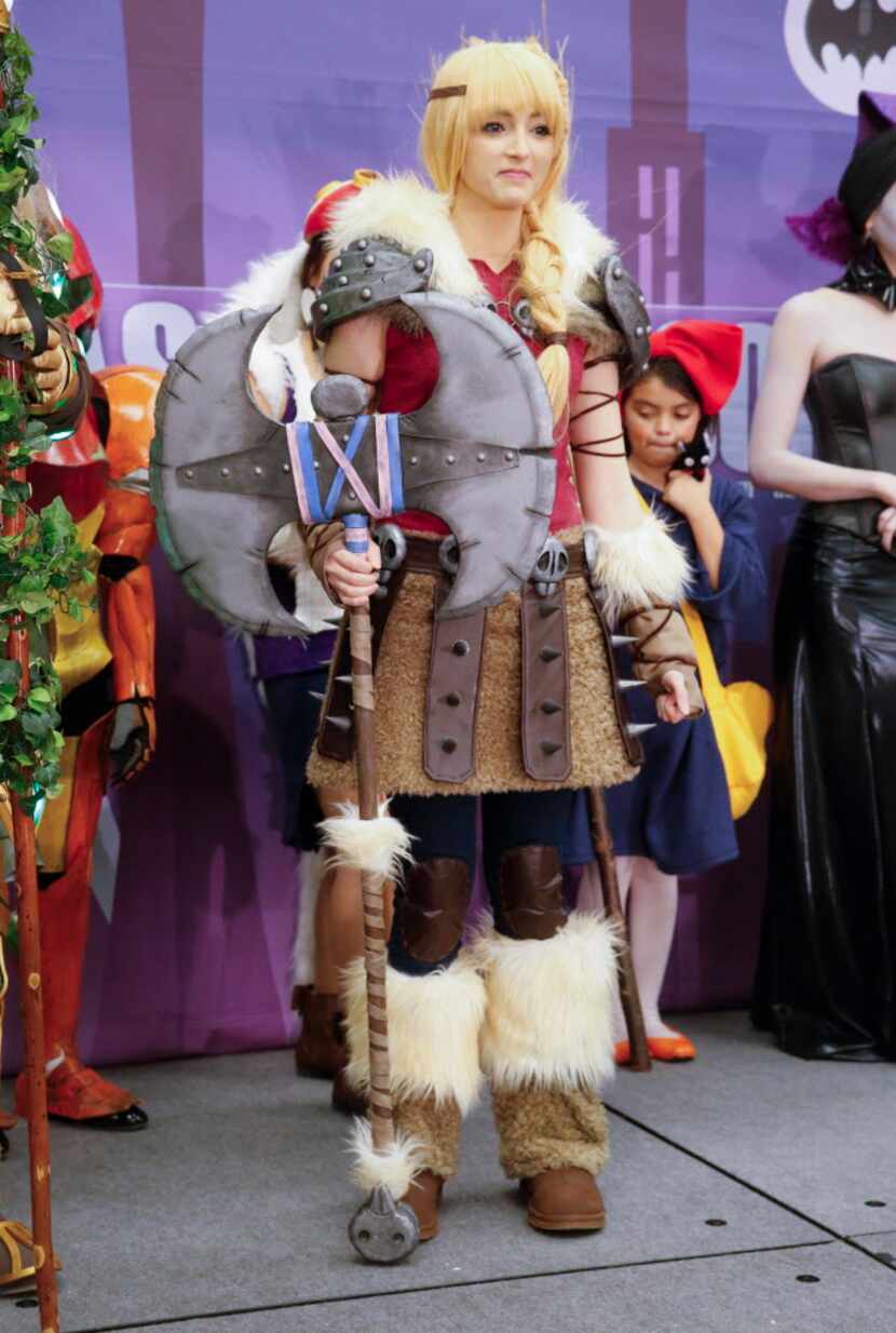 McKenzie LeVan as Astrid Hofferson from How To Train Your Dragon stands on stage with other...