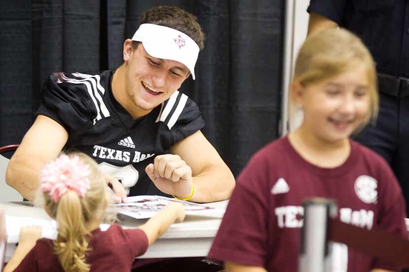 Texas A&M quarterback Johnny Manziel signs autographs during the "Meet the Aggies" event...