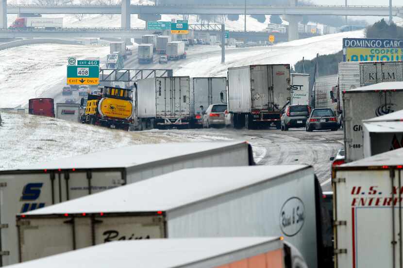 Despite improving road conditions Saturday, a miles-long backup of traffic remained on...