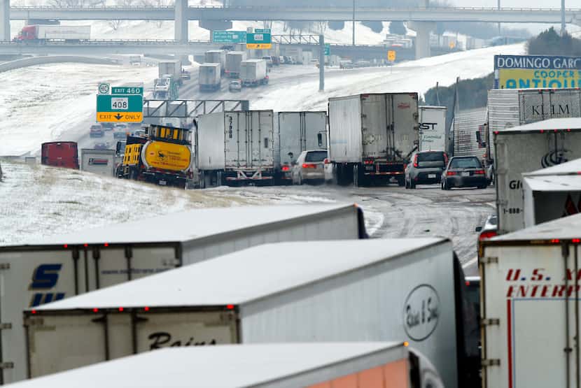 Despite improving road conditions Saturday, a miles-long backup of traffic remained on...