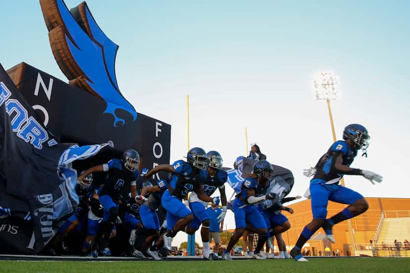 North Forney football players run out before the start of a District 10-6A homecoming...
