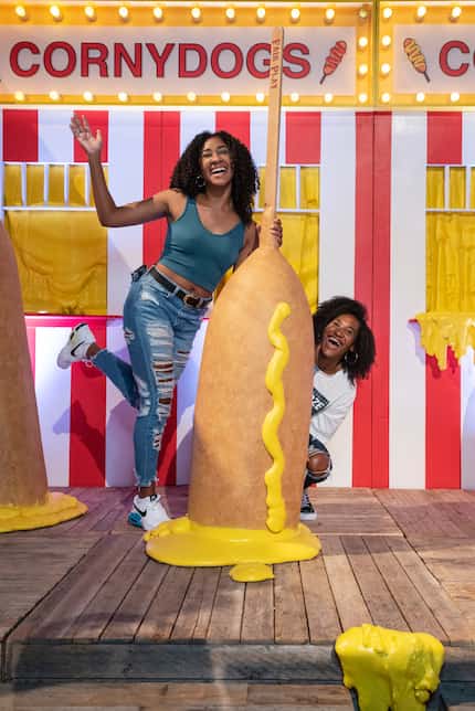 Victoria Roberts, left, and Anastatia Harrison, pose for photos with gigantic corny dogs at...