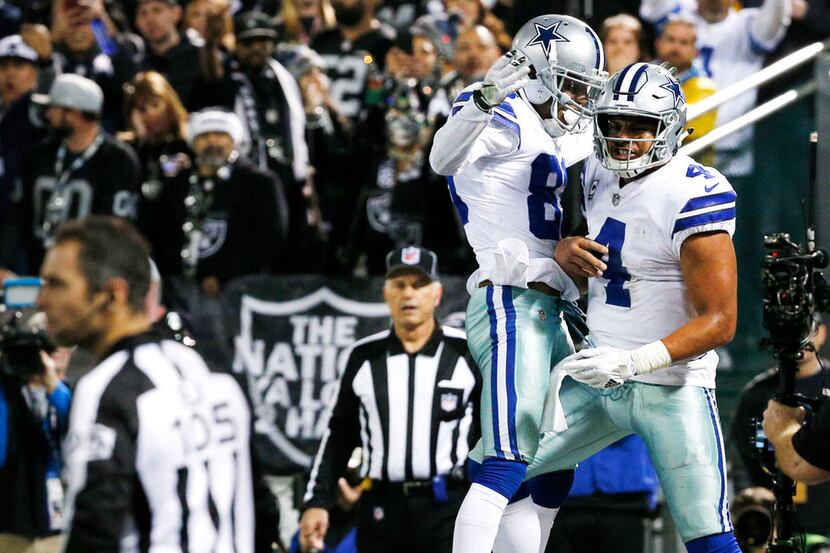 Dallas Cowboys quarterback Dak Prescott (4) celebrates with Dallas Cowboys wide receiver Dez...