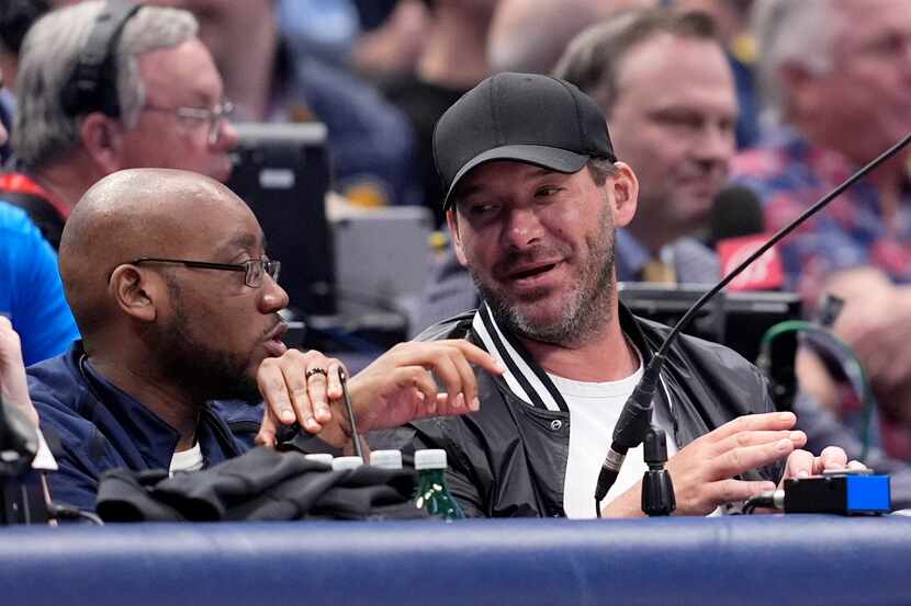 Former NFL quarterback Tony Romo, right, attends an NBA basketball game between the Indiana...