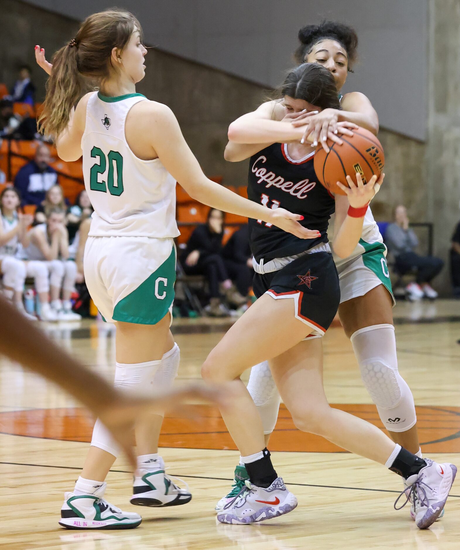 Southlake Carroll sophomore guard Milania Jordan (1, right) tries to take the ball from...