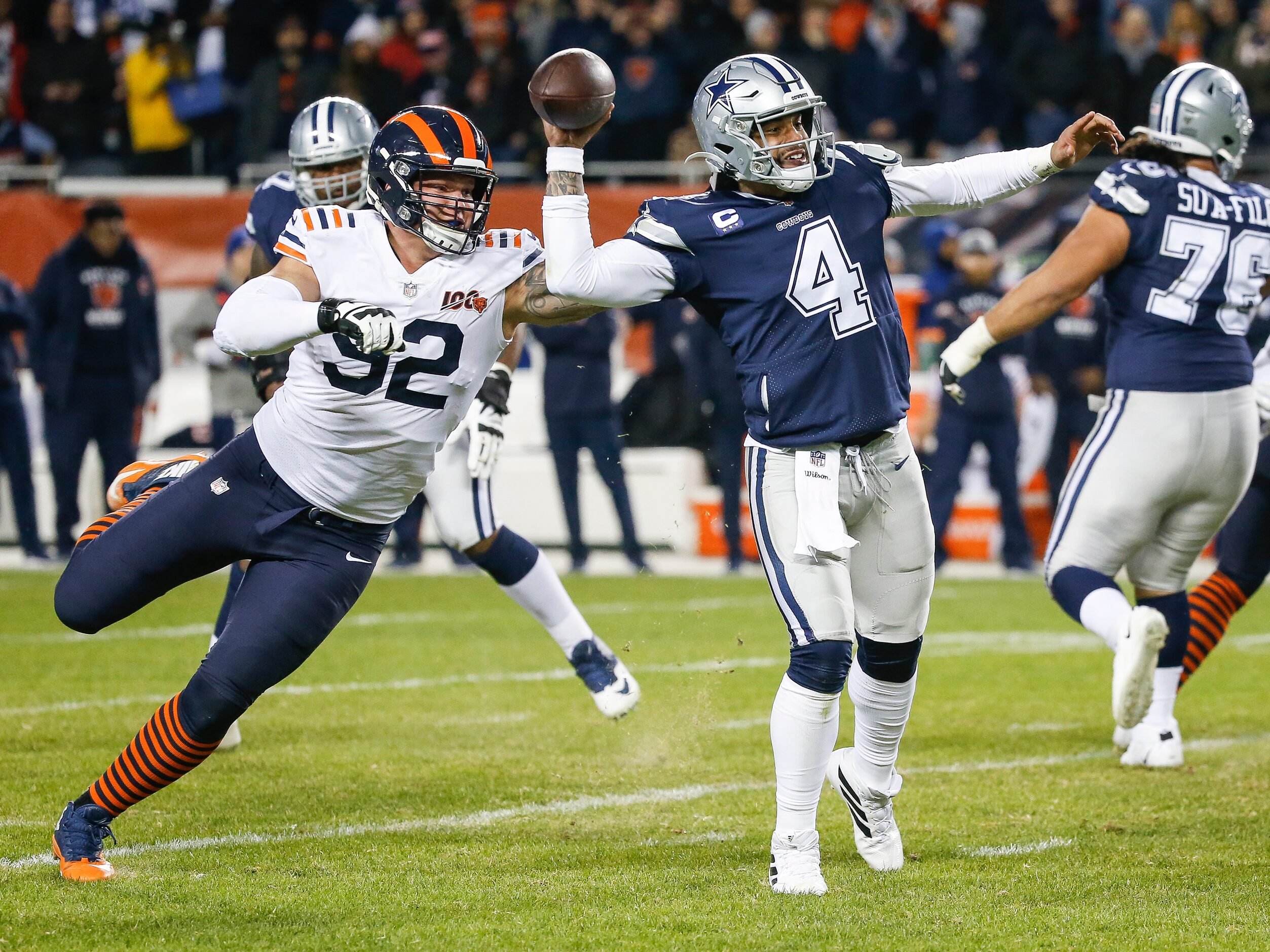 Dallas Cowboys quarterback Dak Prescott (4) fires off a pass before being brought down by...