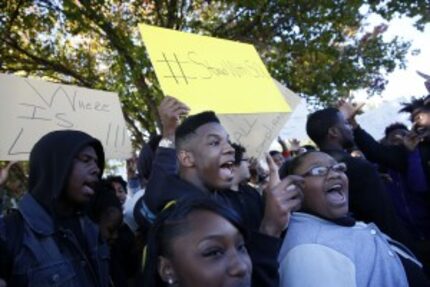  Senior Gerrod Moore (center) was among demonstrators during a walk-out to protest building...