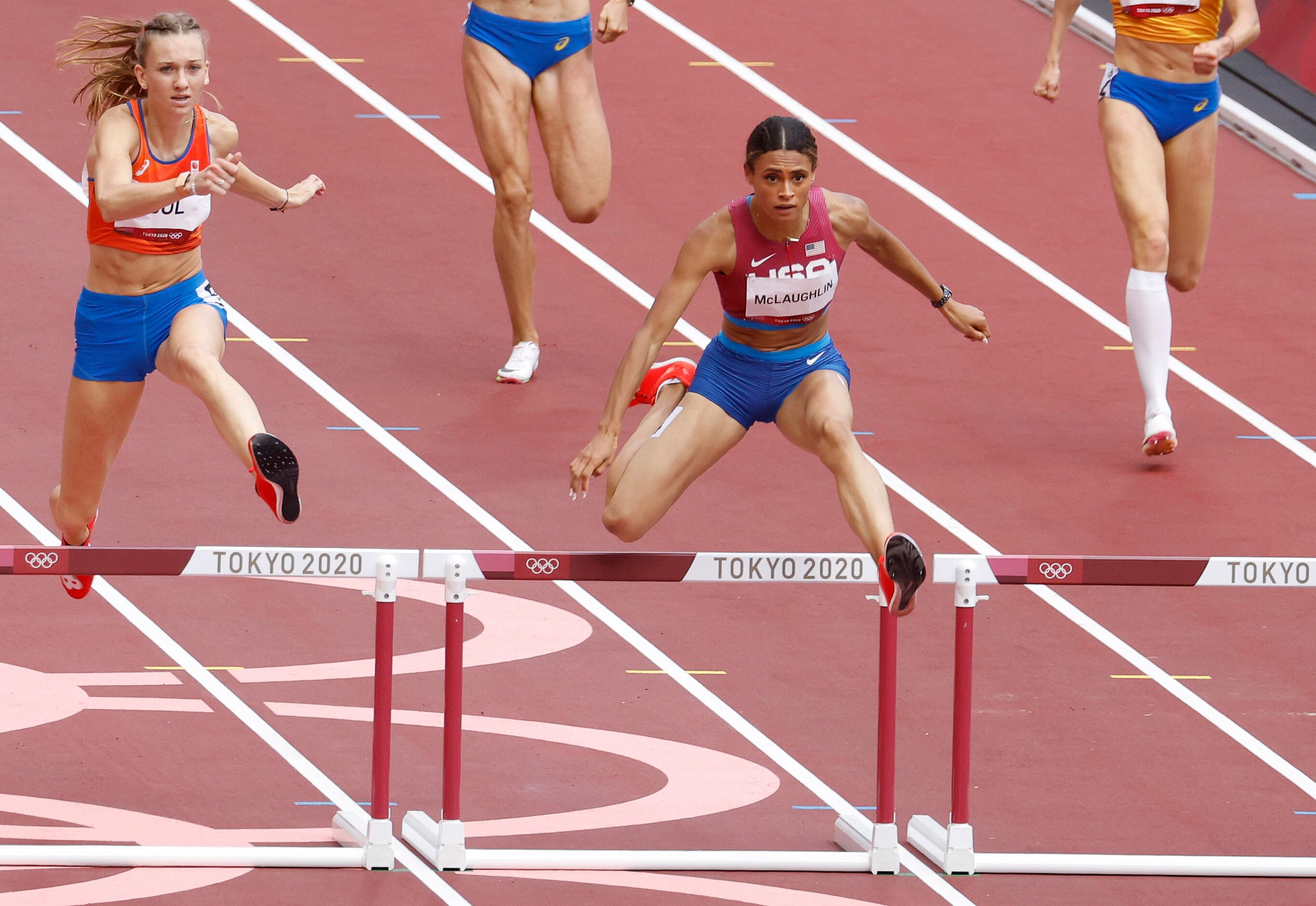 USA’s Sydney McLaughlin and the Netherland’s Femke Bol clear the last hurdle as they race to...