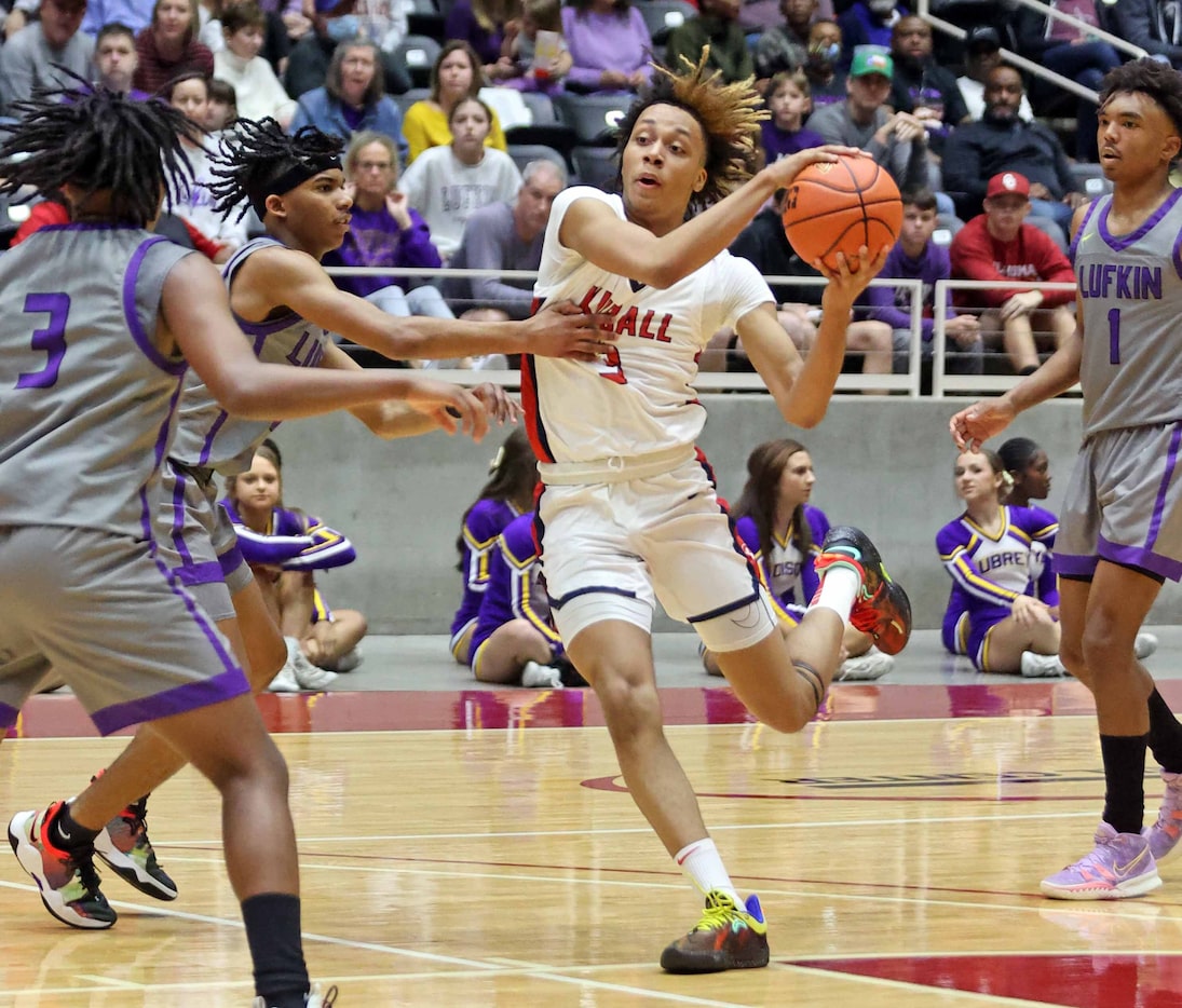 Kimball's Chauncey Gibson (3) drives to the basket between Lufkin defenders during the first...