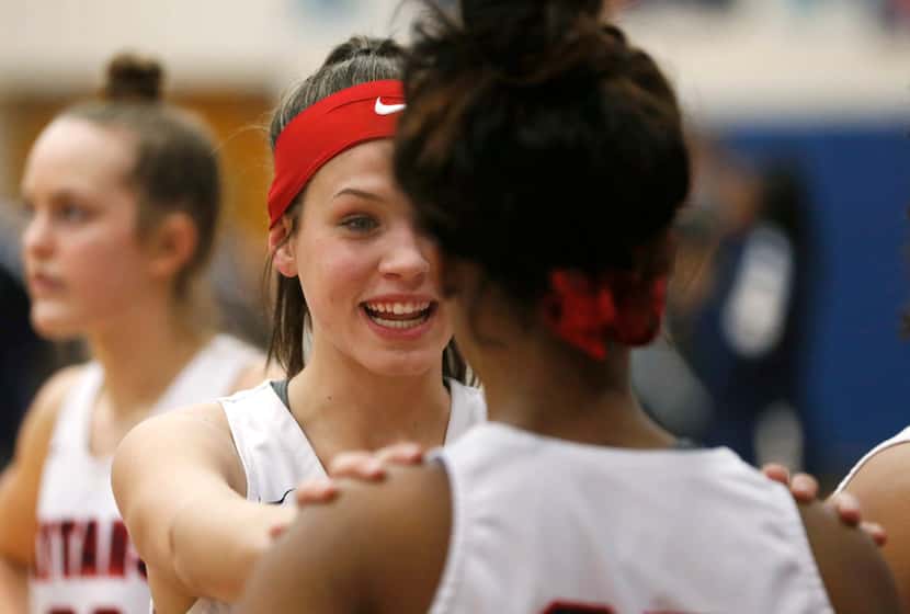 Centennial's Lily Crane talks with teammate DeAsia Gordon (25) during halftime in a game...